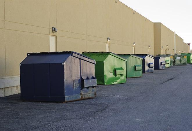 a row of blue construction dumpsters on a job site in Maywood